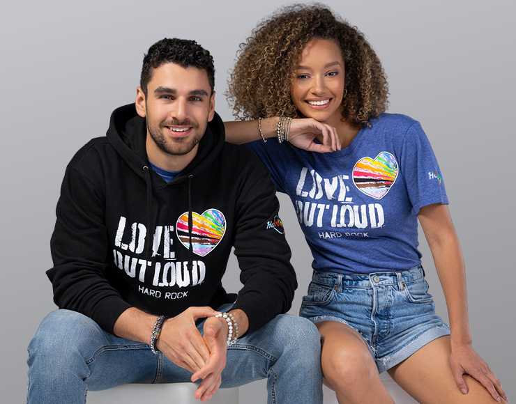 pride 2025 collection with rainbow tumbler and black sweater with a rainbow heart and words love out loud Hard Rock on it